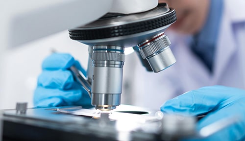 Biotech scientist working with a microscope